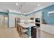 Modern kitchen with white cabinets, granite countertops, and island seating at 707 Winterside Dr, Apollo Beach, FL 33572