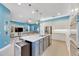 Spacious kitchen featuring granite countertops, stainless steel appliances, and white cabinetry at 707 Winterside Dr, Apollo Beach, FL 33572