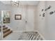 Bright and airy entryway with staircase, rug, and nautical-themed wall decor at 707 Winterside Dr, Apollo Beach, FL 33572