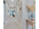 Long hallway with light walls and tile floors, leading to other rooms at 707 Winterside Dr, Apollo Beach, FL 33572