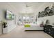 Spacious main bedroom with a comfortable seating area and large TV at 10213 Golden Eagle Dr, Largo, FL 33778
