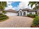 One-story house with a double garage and palm trees at 10213 Golden Eagle Dr, Largo, FL 33778