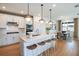 Open concept kitchen island with white cabinets and wood flooring at 6655 Michael Favor Way, Wesley Chapel, FL 33545