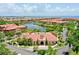 Resort-style community clubhouse with swimming pool and lush landscaping at 2717 Via Cipriani # 622B, Clearwater, FL 33764