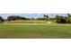 View of lush green golf course with lake and distant homes at 1901 Oyster Catcher Ln # 814, Clearwater, FL 33762