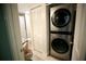 Small laundry room with stacked washer and dryer at 1901 Oyster Catcher Ln # 814, Clearwater, FL 33762