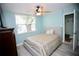 Light blue bedroom with a queen bed, dresser, and window at 1901 Oyster Catcher Ln # 814, Clearwater, FL 33762