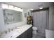 Updated bathroom with grey vanity and patterned shower curtain at 1901 Oyster Catcher Ln # 814, Clearwater, FL 33762