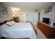 Bedroom with queen bed, wood furniture, and access to bathroom at 1901 Oyster Catcher Ln # 814, Clearwater, FL 33762
