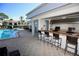 Outdoor kitchen and bar area adjacent to the pool at 1901 Oyster Catcher Ln # 814, Clearwater, FL 33762