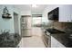 Modern kitchen featuring stainless steel appliances and granite countertops at 1901 Oyster Catcher Ln # 814, Clearwater, FL 33762