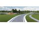 Vida's Way entrance with landscaping, winding paths, and a windmill at 6659 Michael Favor Way, Wesley Chapel, FL 33545