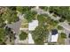 Aerial shot of the home showing the roof, surrounding trees, and the neighborhood layout at 1802 E Hamilton Ave, Tampa, FL 33610