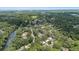 Overhead view of a neighborhood surrounded by lush greenery, with a river nearby at 1802 E Hamilton Ave, Tampa, FL 33610