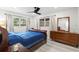 A cozy bedroom with a big dresser and natural light streaming through the windows at 1802 E Hamilton Ave, Tampa, FL 33610