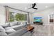 Bright living room features a large window offering a view of the landscaped exterior at 1802 E Hamilton Ave, Tampa, FL 33610