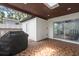 Spacious covered patio with outdoor cooking area and tile flooring at 1802 E Hamilton Ave, Tampa, FL 33610