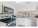 Modern kitchen featuring stainless steel appliances and white cabinetry at 19725 Gulf Blvd # 20, Indian Shores, FL 33785