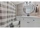 Updated bathroom with white vanity and gray striped shower curtain at 19725 Gulf Blvd # 20, Indian Shores, FL 33785