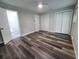 Spacious bedroom with double closets and wood-look floors at 3233 Lenwood Dr, New Port Richey, FL 34655