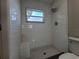 Updated shower with white tile and built-in seat at 3233 Lenwood Dr, New Port Richey, FL 34655