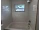 New bathtub with bright white tile surround at 3233 Lenwood Dr, New Port Richey, FL 34655