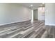 Spacious living room featuring gray walls and wood-look flooring at 3233 Lenwood Dr, New Port Richey, FL 34655