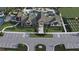 Community aerial view showcasing the pool, clubhouse, tennis court, and garden at 6681 Michael Favor Way, Wesley Chapel, FL 33545
