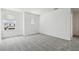 Bedroom featuring neutral carpet, bright walls and large windows with bright natural light at 6681 Michael Favor Way, Wesley Chapel, FL 33545