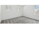 Bright bedroom features plush gray carpet and large windows with blinds at 6681 Michael Favor Way, Wesley Chapel, FL 33545