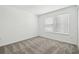 A bright bedroom features neutral carpeting, two windows with blinds, and a serene atmosphere at 6681 Michael Favor Way, Wesley Chapel, FL 33545