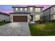 Beautiful two-story home with a paved driveway and attached two-car garage at 6681 Michael Favor Way, Wesley Chapel, FL 33545