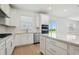 This kitchen has modern appliances and fixtures, plenty of natural light, and a practical kitchen island at 6681 Michael Favor Way, Wesley Chapel, FL 33545