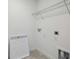 Functional laundry room equipped with shelving, connections, and a utility sink at 6681 Michael Favor Way, Wesley Chapel, FL 33545