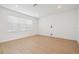 Bright room with a modern aesthetic, featuring hardwood floors and a neutral color palette at 6681 Michael Favor Way, Wesley Chapel, FL 33545