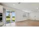 The expansive living area opens to a patio with verdant outdoor views at 6681 Michael Favor Way, Wesley Chapel, FL 33545