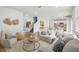 Bright, open-concept living room featuring hardwood floors and modern decor at 6681 Michael Favor Way, Wesley Chapel, FL 33545