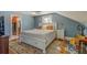 Main bedroom with large bed, hardwood floors, and access to bathroom at 615 Grove N St, St Petersburg, FL 33701