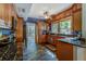 Modern kitchen with wood cabinets, granite countertops, and tile floors at 615 Grove N St, St Petersburg, FL 33701