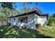 Back of house showing a large yard at 1802 E Hamilton Ave, Tampa, FL 33610