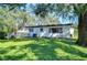 Spacious backyard with lush lawn and large trees at 1802 E Hamilton Ave, Tampa, FL 33610