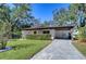 Updated home exterior with modern finishes and landscaping at 1802 E Hamilton Ave, Tampa, FL 33610