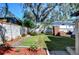 Backyard features a brick grill and a well-manicured lawn at 1802 E Hamilton Ave, Tampa, FL 33610