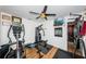 Home gym with multiple exercise machines and wood floors at 13191 92Nd Ave, Seminole, FL 33776