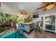 Outdoor patio with tiki bar, seating area, and lush tropical landscaping at 13191 92Nd Ave, Seminole, FL 33776