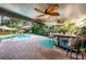 Covered patio with pool, tiki bar, and brick pavers at 13191 92Nd Ave, Seminole, FL 33776