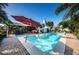 Relaxing pool and spa with patio and shade umbrellas at 13191 92Nd Ave, Seminole, FL 33776