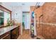 Bathroom with walk-in shower, granite vanity, and access to bedroom at 13191 92Nd Ave, Seminole, FL 33776