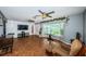 Living room with tile floors, ceiling fan, and views to dining area and entryway at 13191 92Nd Ave, Seminole, FL 33776