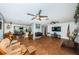 Open living room with tile floors, ceiling fans and views to kitchen and dining areas at 13191 92Nd Ave, Seminole, FL 33776